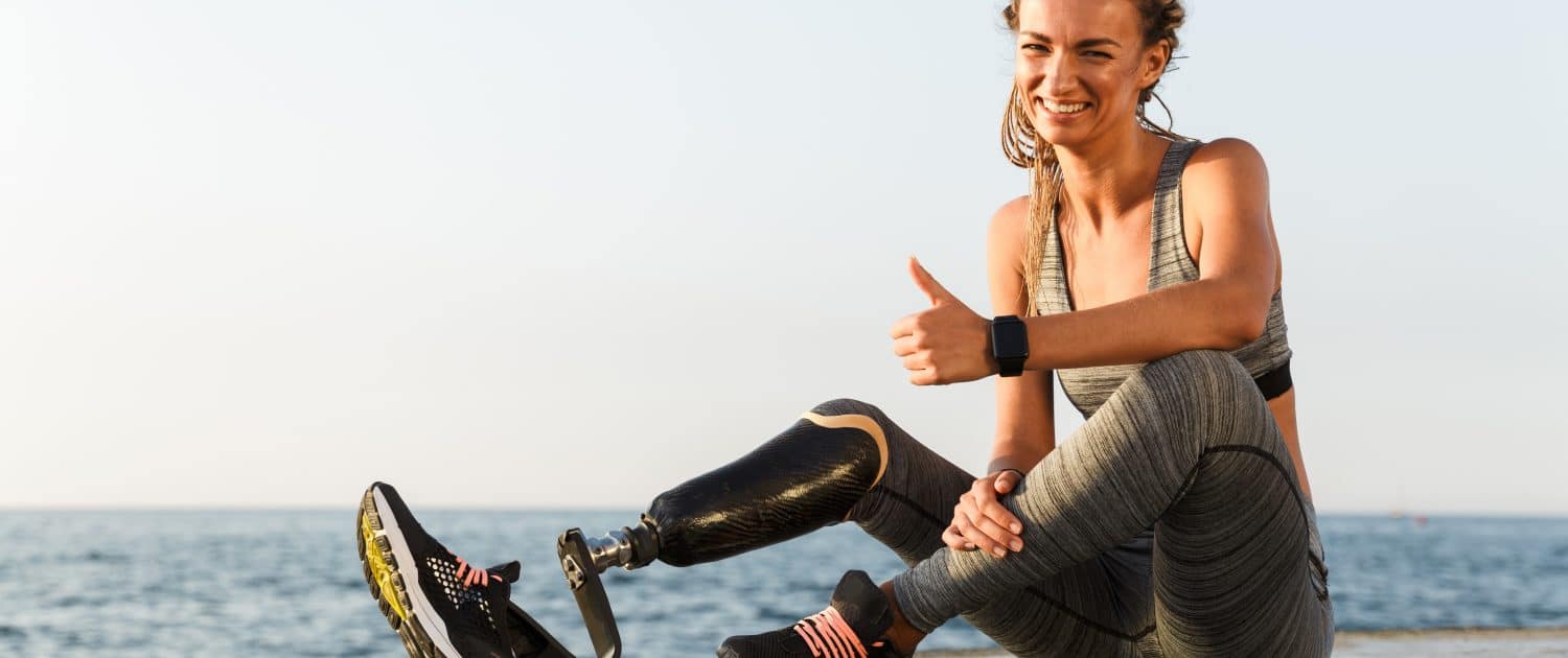 Smiling disabled athlete woman with prosthetic leg